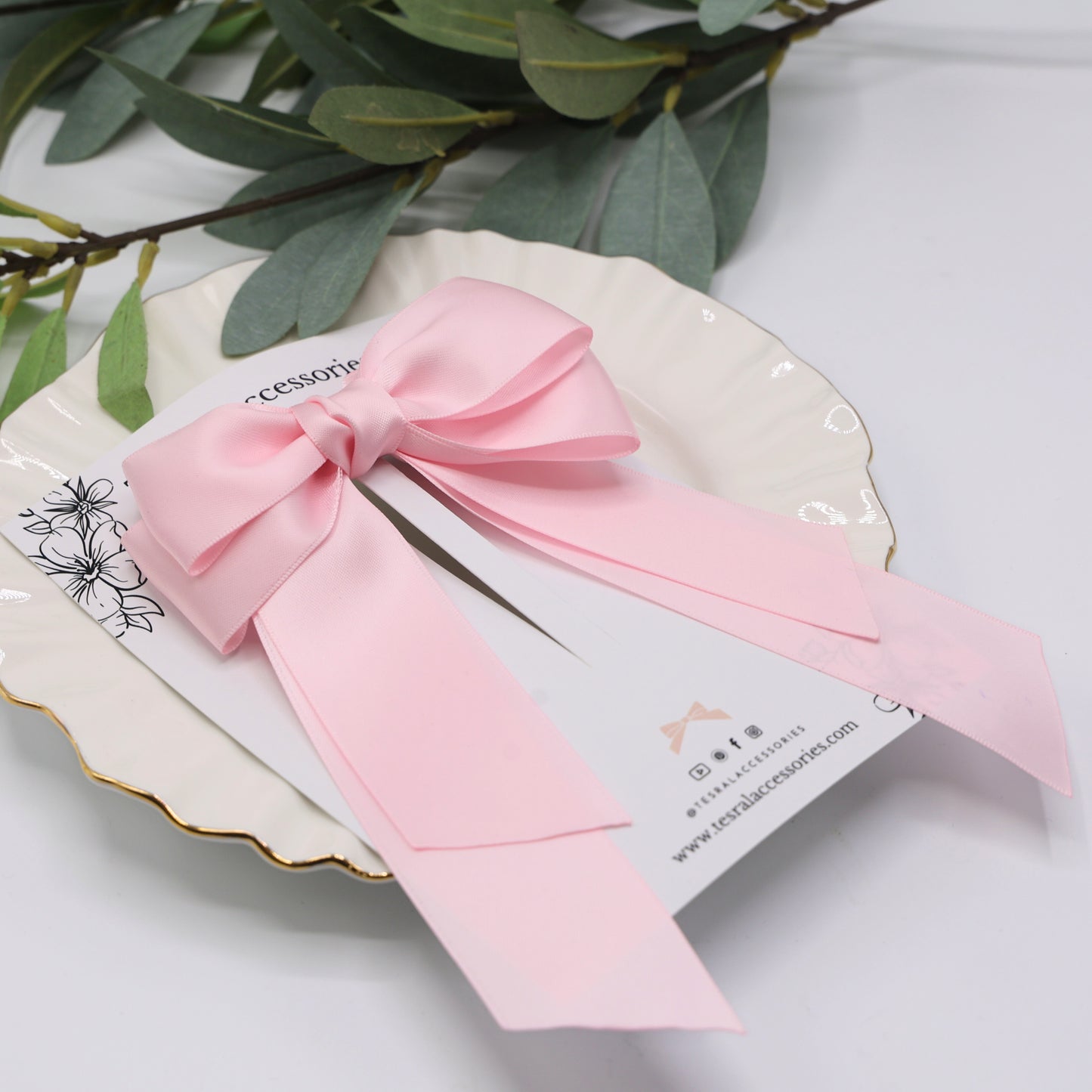 Close-up of Tesral Cascade Pearl Pink Bow, detailing smooth double-sided satin fabric and secure barrette mechanism.