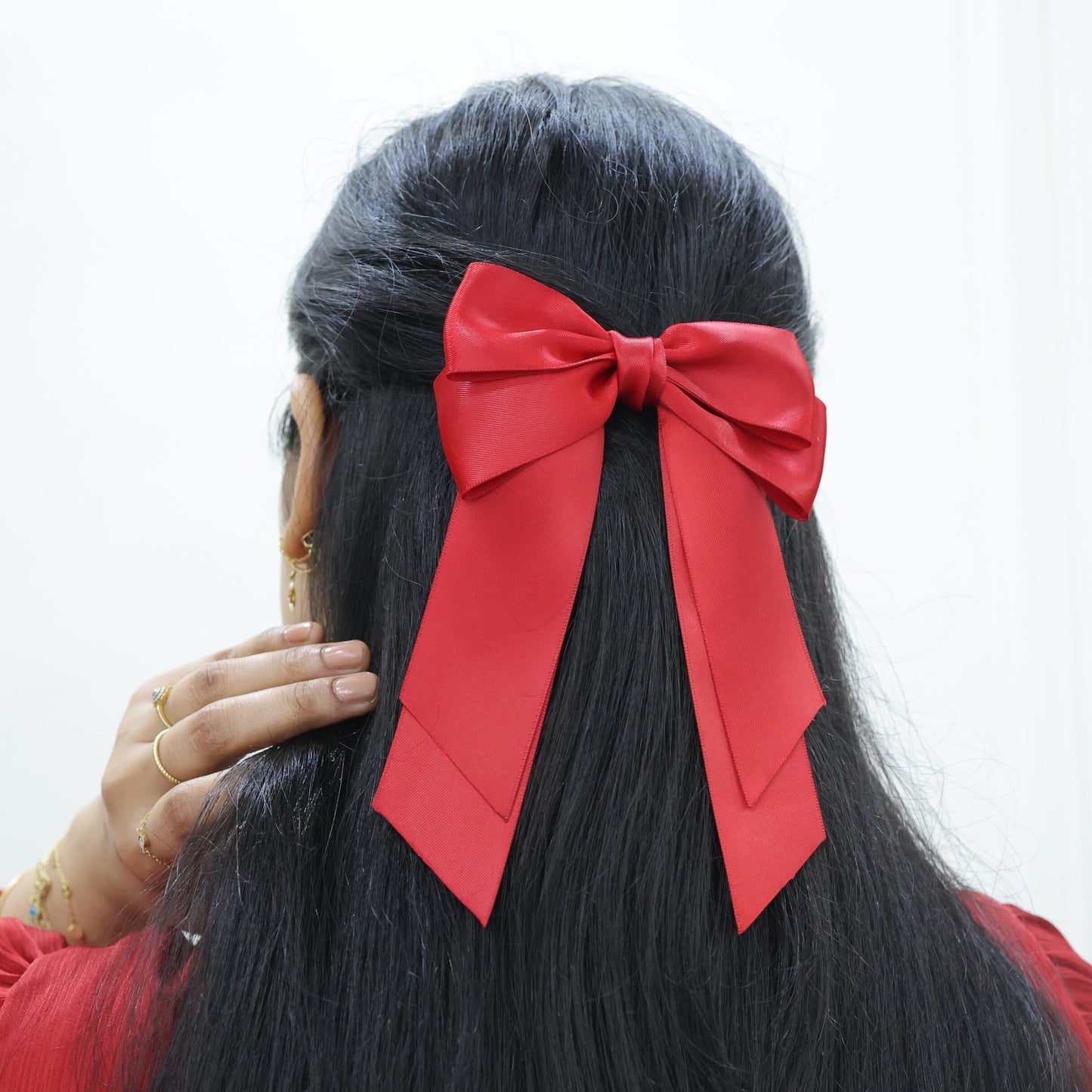 Model wearing Tesral Cascade Scarlet Red Bow, displaying long cascading tails and elegant silhouette for formal occasions.