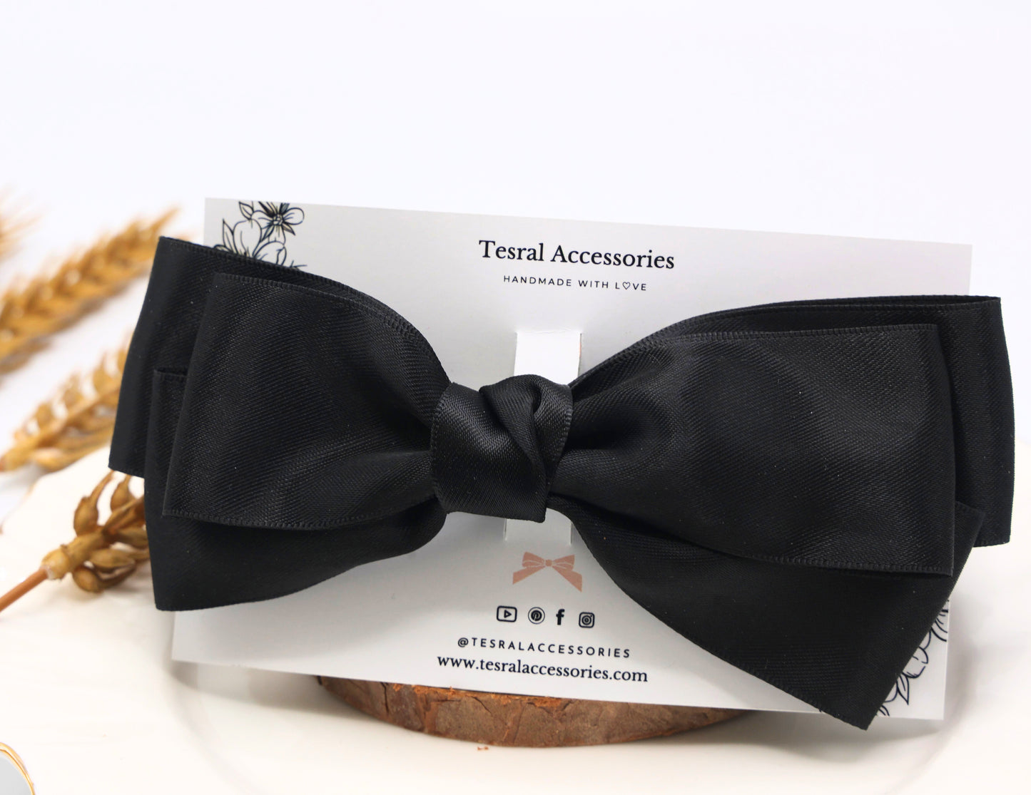 Close-up of Tesral Diana Bow in Black, highlighting the luxurious satin ribbon texture and elegant triple-layer silhouette.