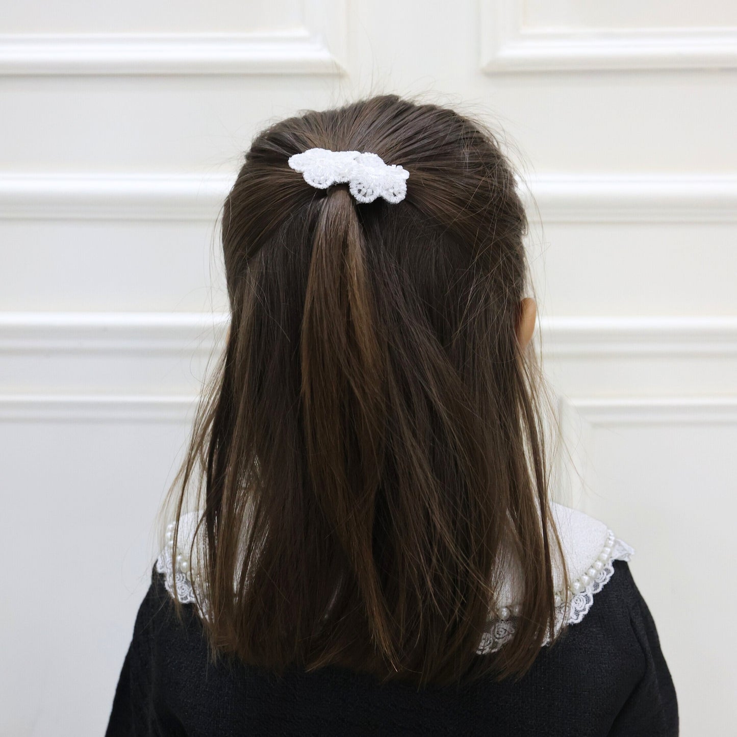 Model wearing Tesral Embellished Bloom Clips in hair, demonstrating how floral appliqués add graceful sparkle to a hairstyle.