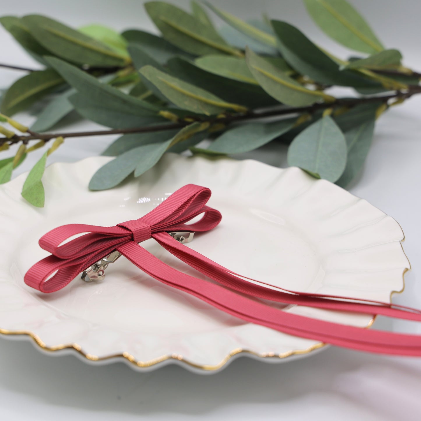 Close-up of Tesral Ethereal Colonial Rose Hair Bow, detailed view of subtle muted rose color and grosgrain texture.