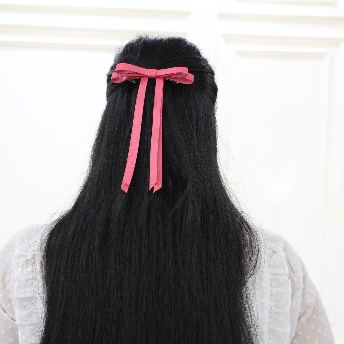 Model wearing Tesral Ethereal Colonial Rose Hair Bow, displaying elegant muted rose shade as a subtle hair accessory.