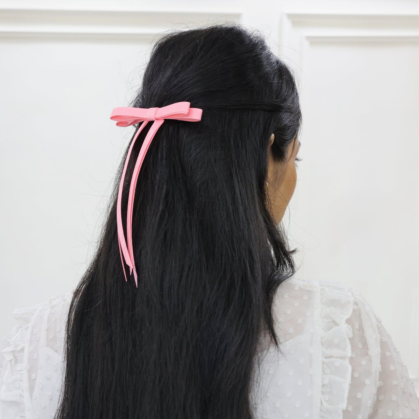 Model wearing Tesral Ethereal Pearl Pink Hair Bow, showing delicate hue and polished understated aesthetic in hairstyle.