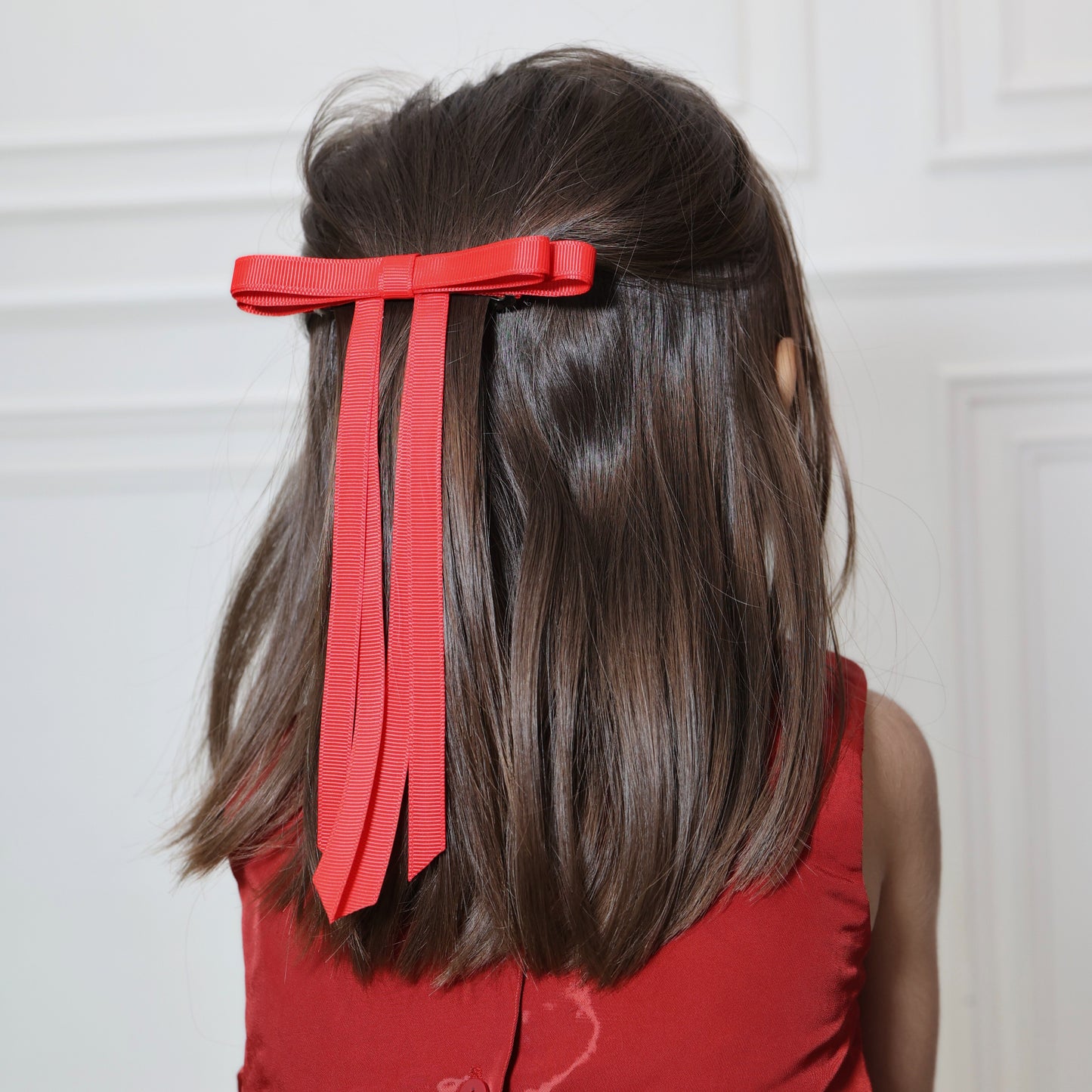 Model wearing Tesral Ethereal Red Hair Bow, making a bold statement with the vibrant red color in a chic hairstyle.