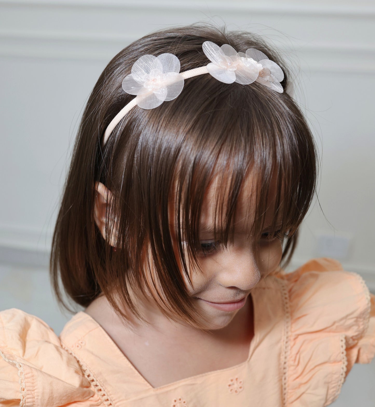 Little girl wearing Tiara Bloom Peach set – sweet floral hairbands by Tesral Accessories