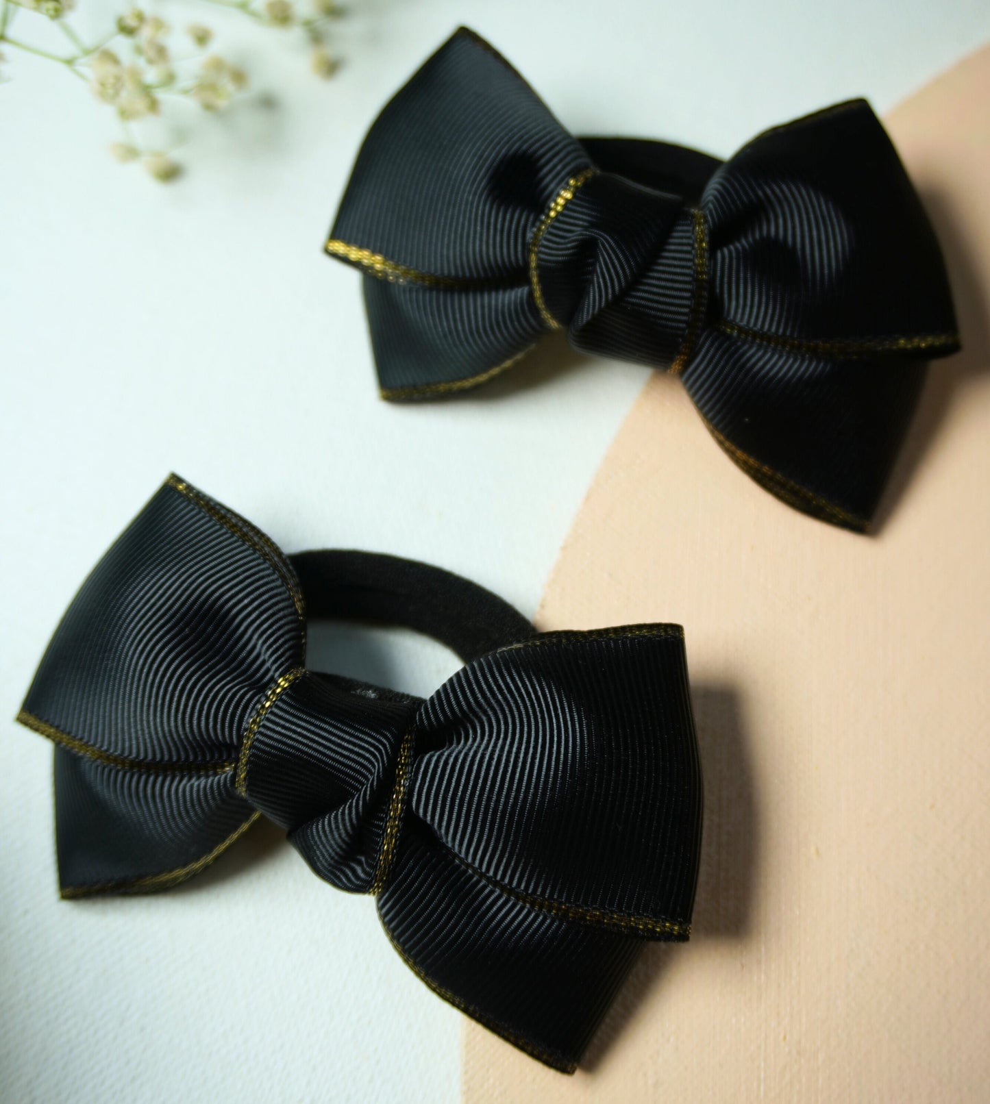 Set of two black grosgrain ribbon bow hair ties with gold metallic edge