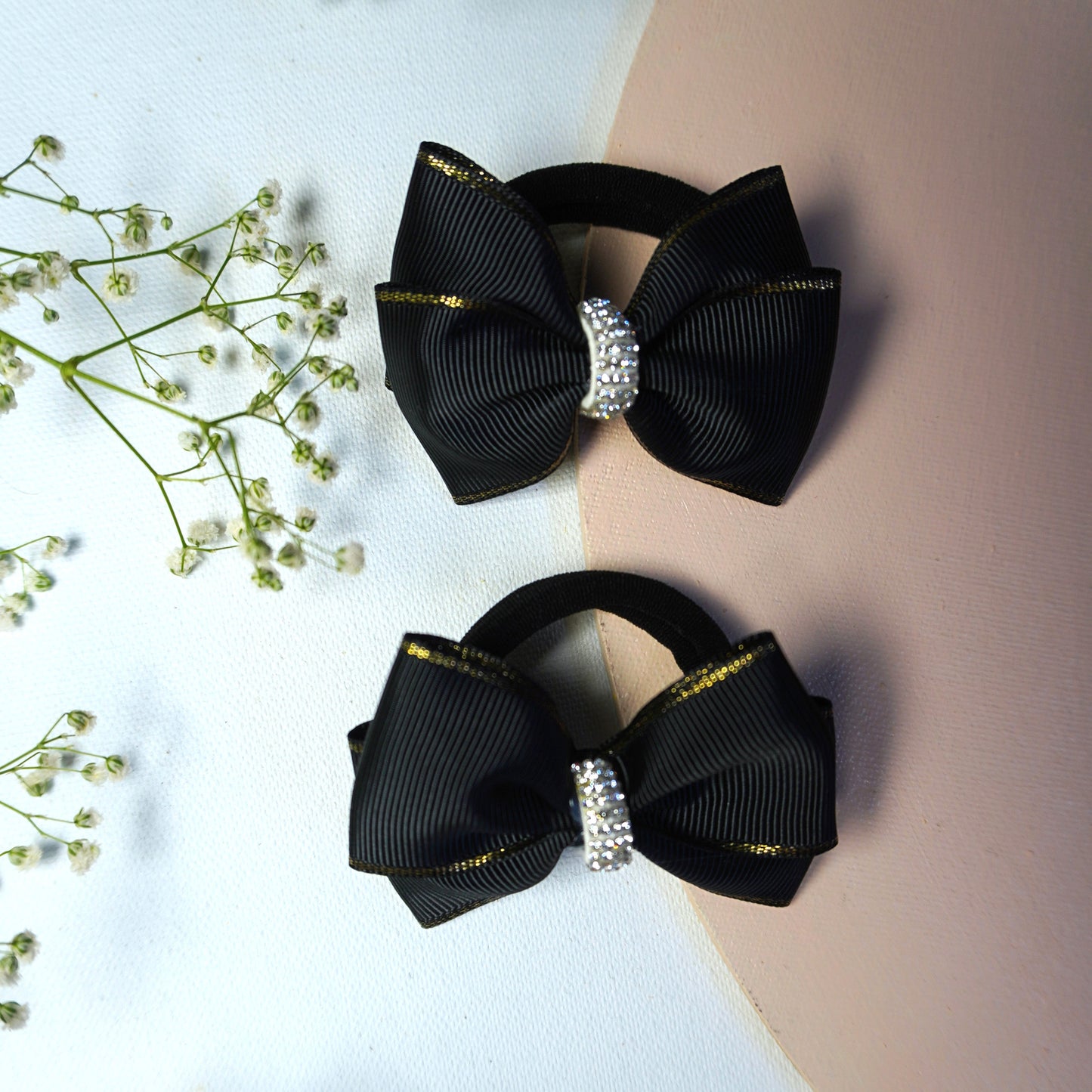 Close-up of black grosgrain bow hair tie with rhinestone and golden edge – Tesral Accessories