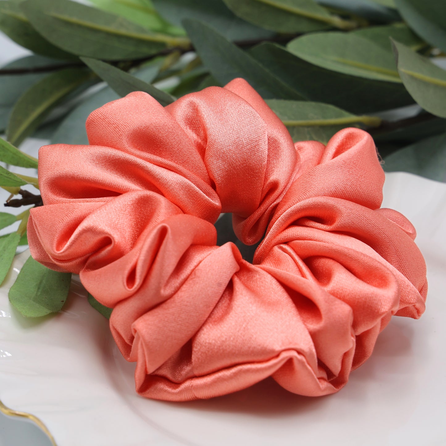 Close-up of Peach Whirl Scrunchie showing smooth satin finish and gentle stretch texture.