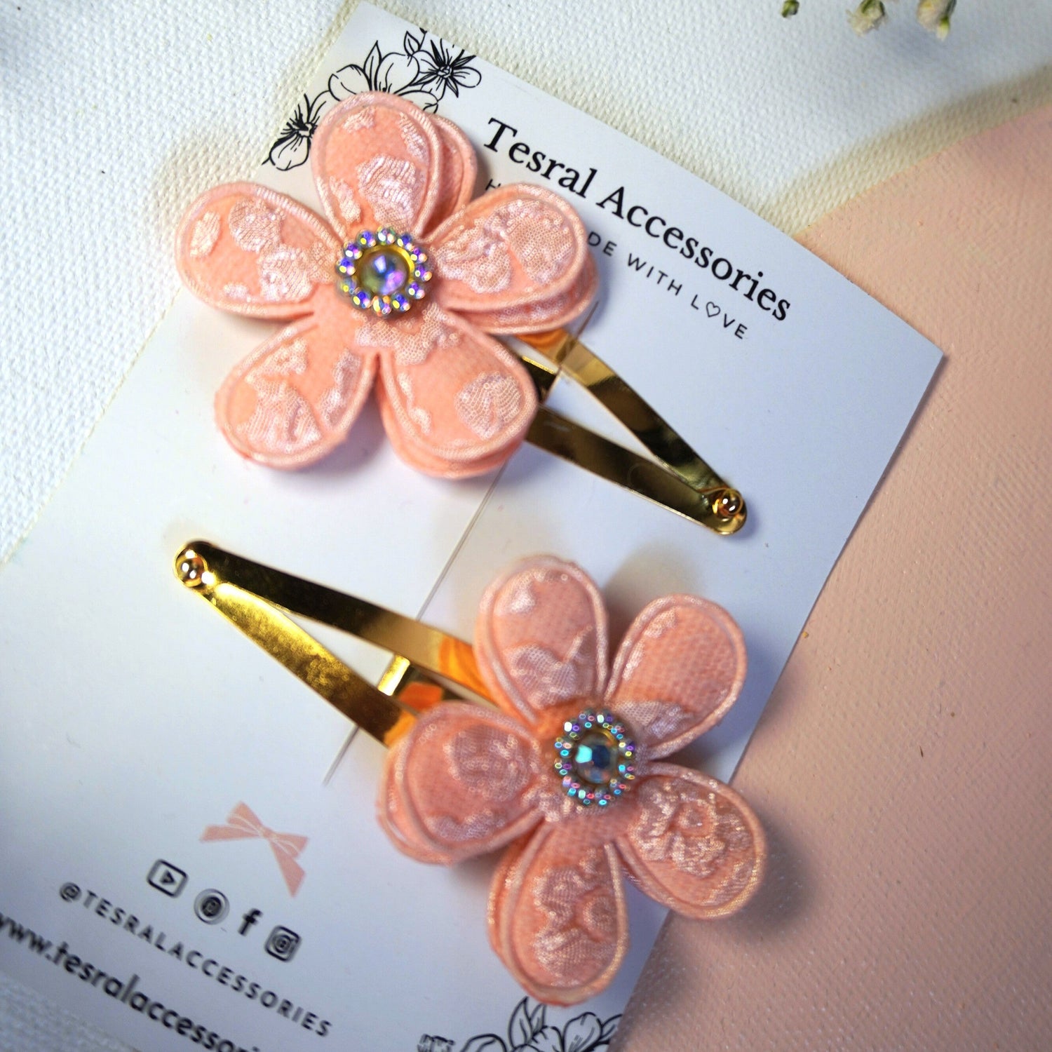 Peach flower hair clips on a card with floral background