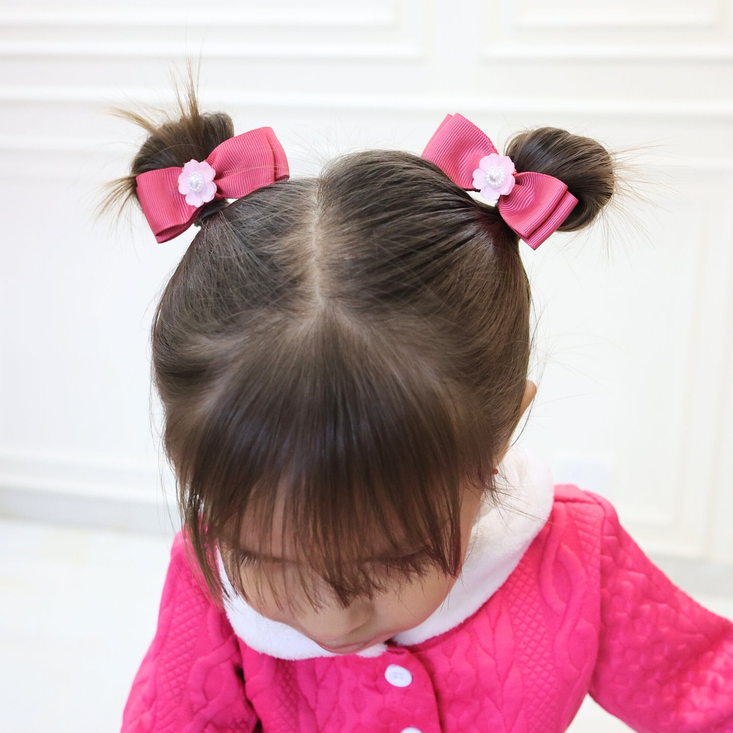 Child wearing Tesral Pearly Pink Hair Bows for an elegant and sweet birthday outfit.