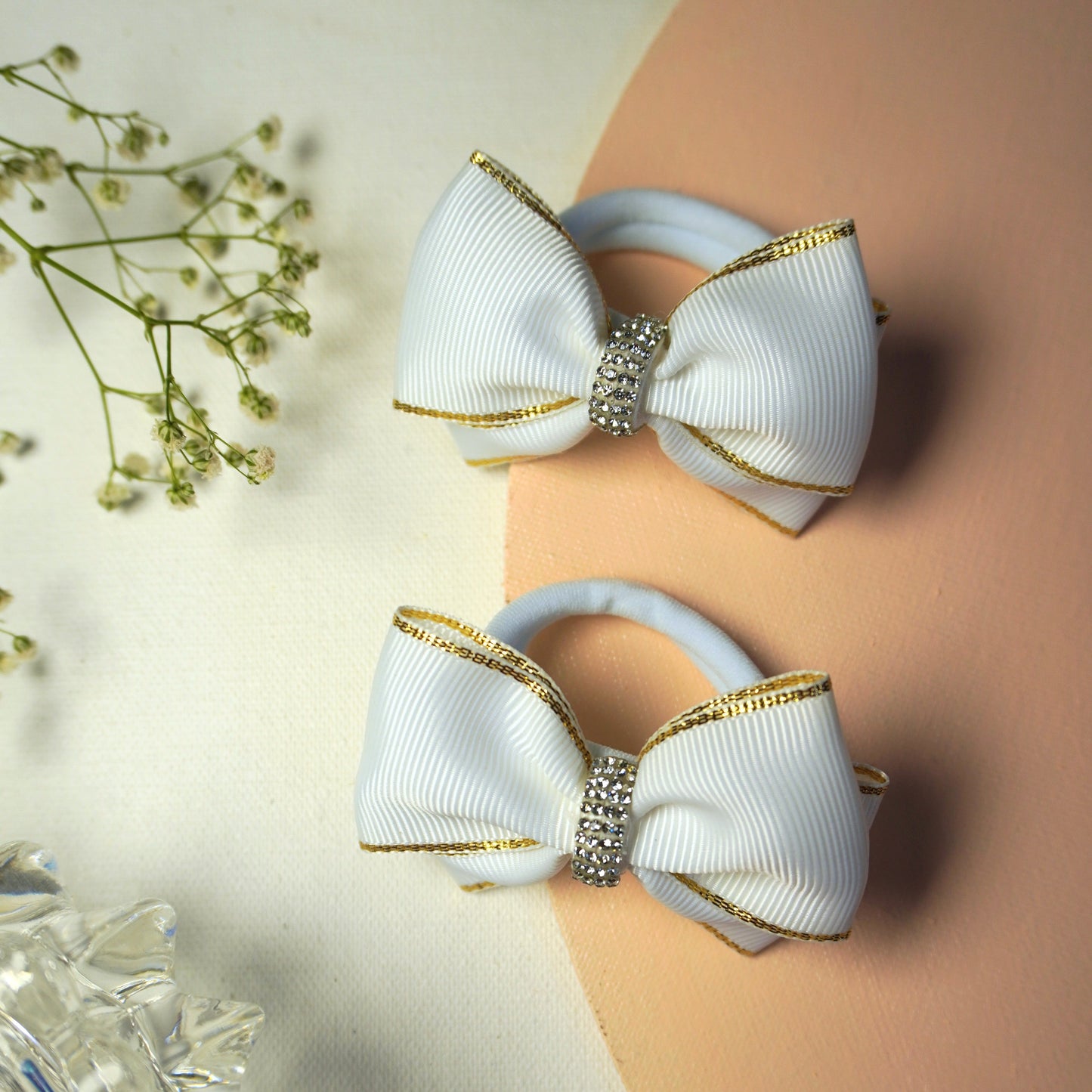 Detailed shot of white bow with sparkly rhinestone centerpiece and grosgrain texture – Tesral Accessories