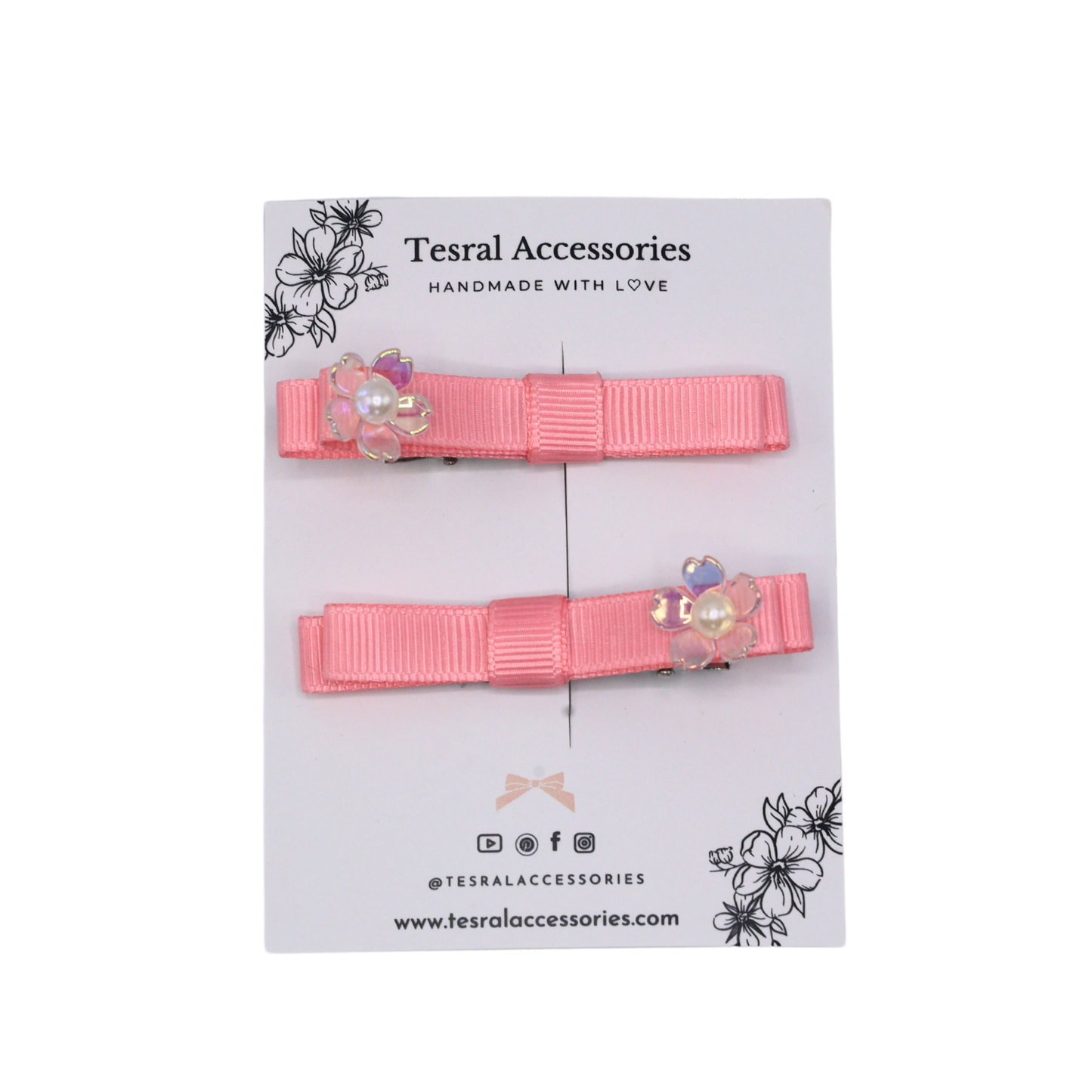 Two pink hair clips with floral accents set on a alligator clip 