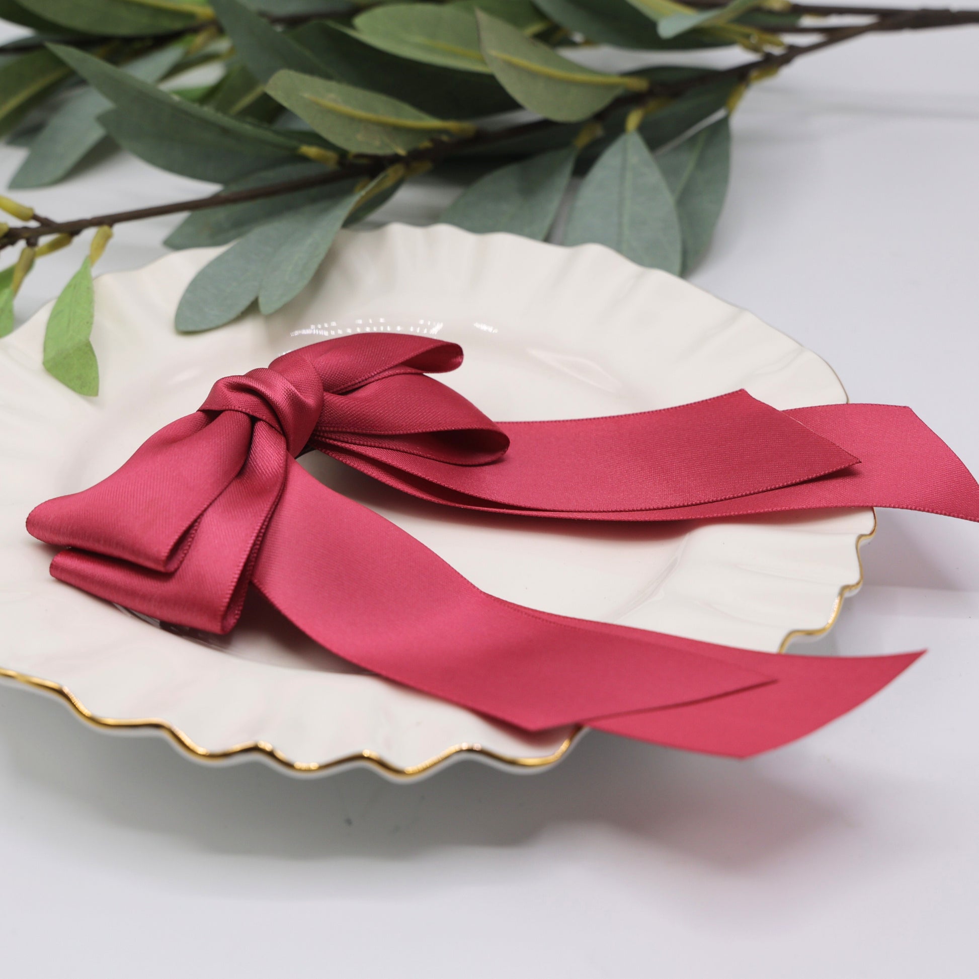 Close-up of Tesral Cascade Colonial Rose Hair Bow, detailing soft rose hues of satin ribbon and precise bow construction.