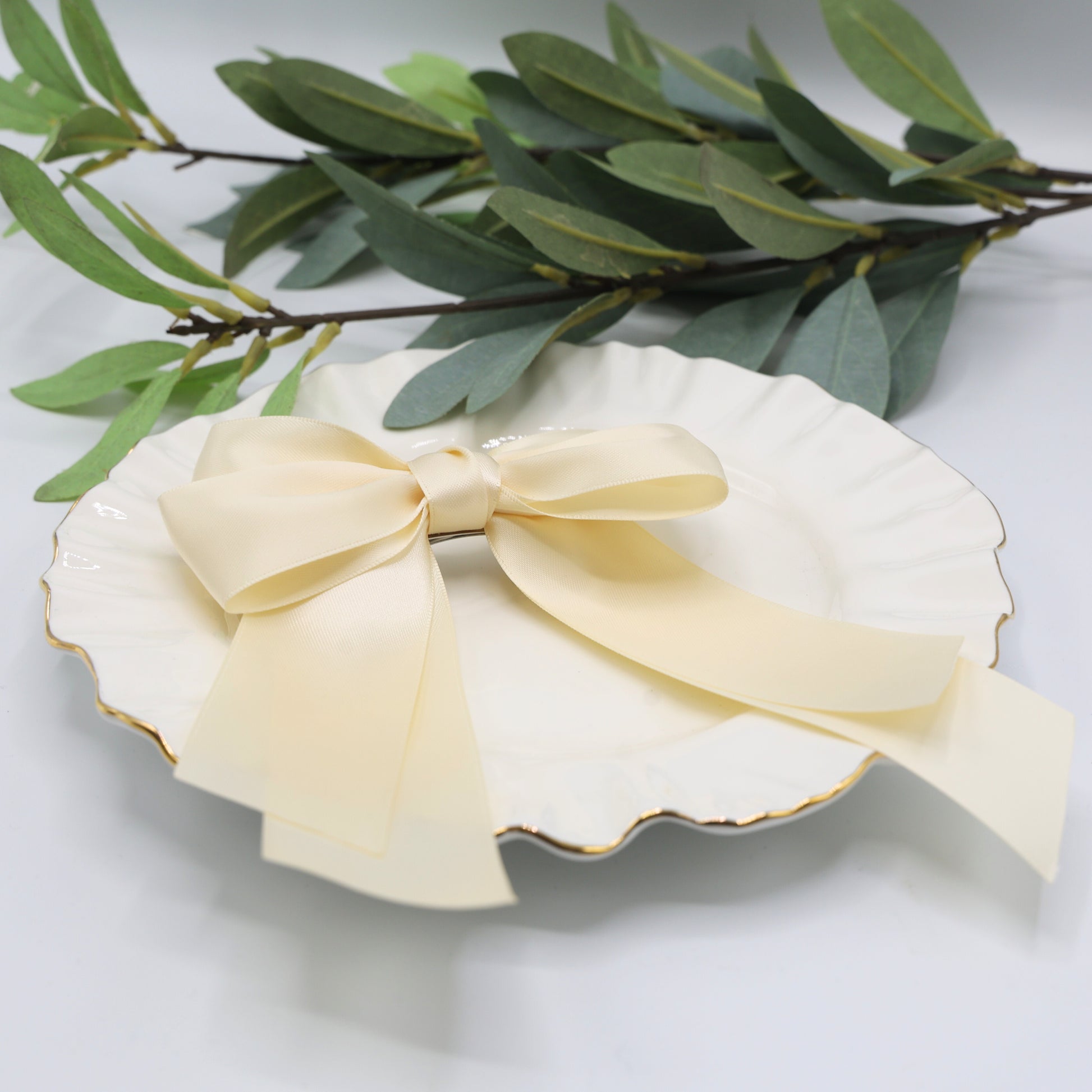 Close-up of Tesral Cascade Ivory Satin Bow, showing luxurious sheen of double-sided satin ribbon and graceful layered design.