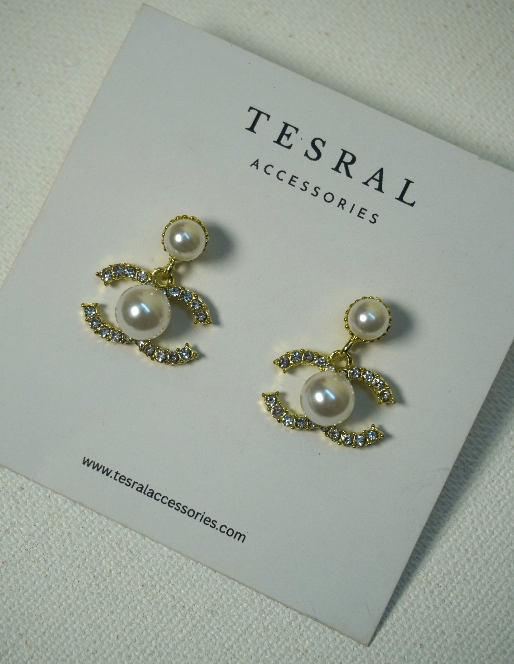 Chanel inspired Pearl earrings on a Tesral Accessories card.