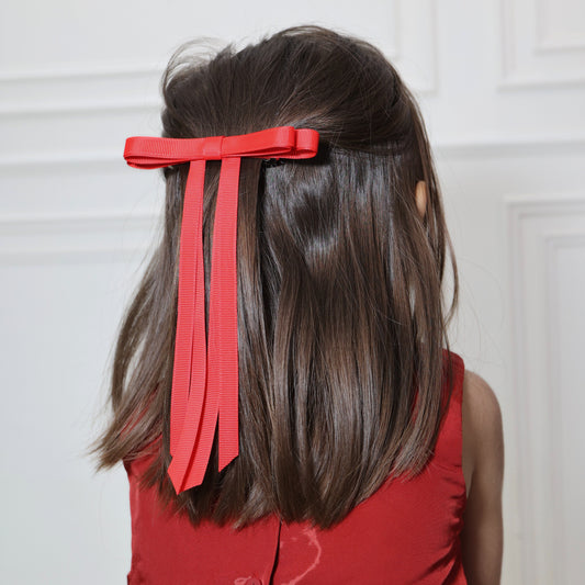 Model wearing Tesral Ethereal Red Hair Bow, making a bold statement with the vibrant red color in a chic hairstyle.