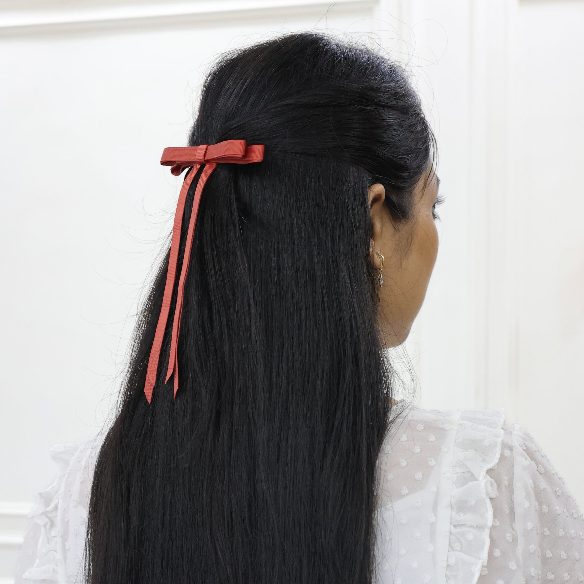Woman styling Ethereal Rust grosgrain bow – sleek hair bow with layer long tails by Tesral Accessories