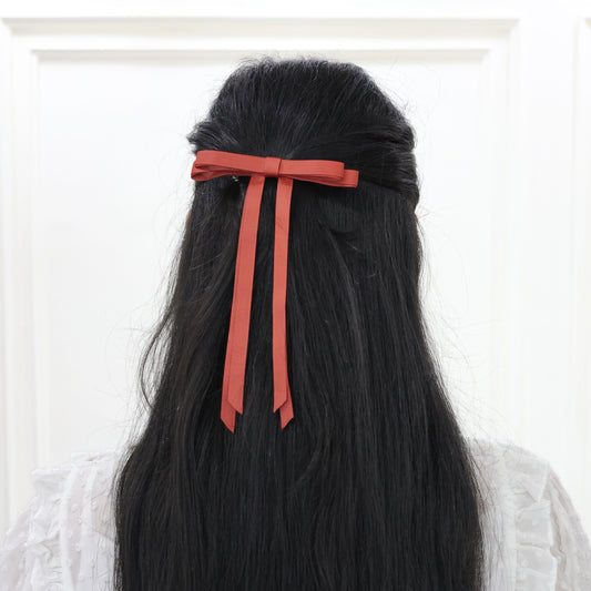 Woman styling Ethereal Rust grosgrain bow – bold yet graceful women hair bow set on French barrette by Tesral Accessories