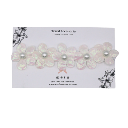 Close-up of Fairy Frost’s iridescent petals and soft elastic band for newborn comfort