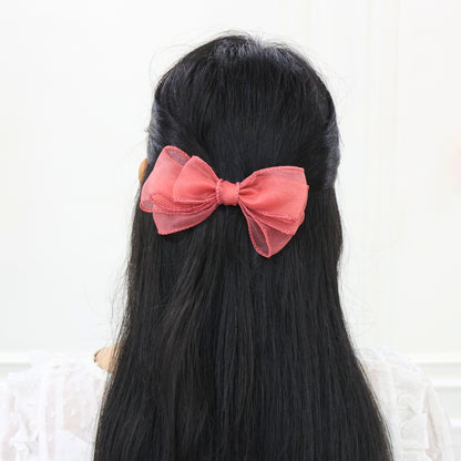 Model wearing Glow Bow – ethereal sheer hair accessory for special events by Tesral Accessories