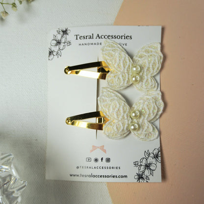 Gold tic-tac clips with delicate white butterfly appliqués for special occasions