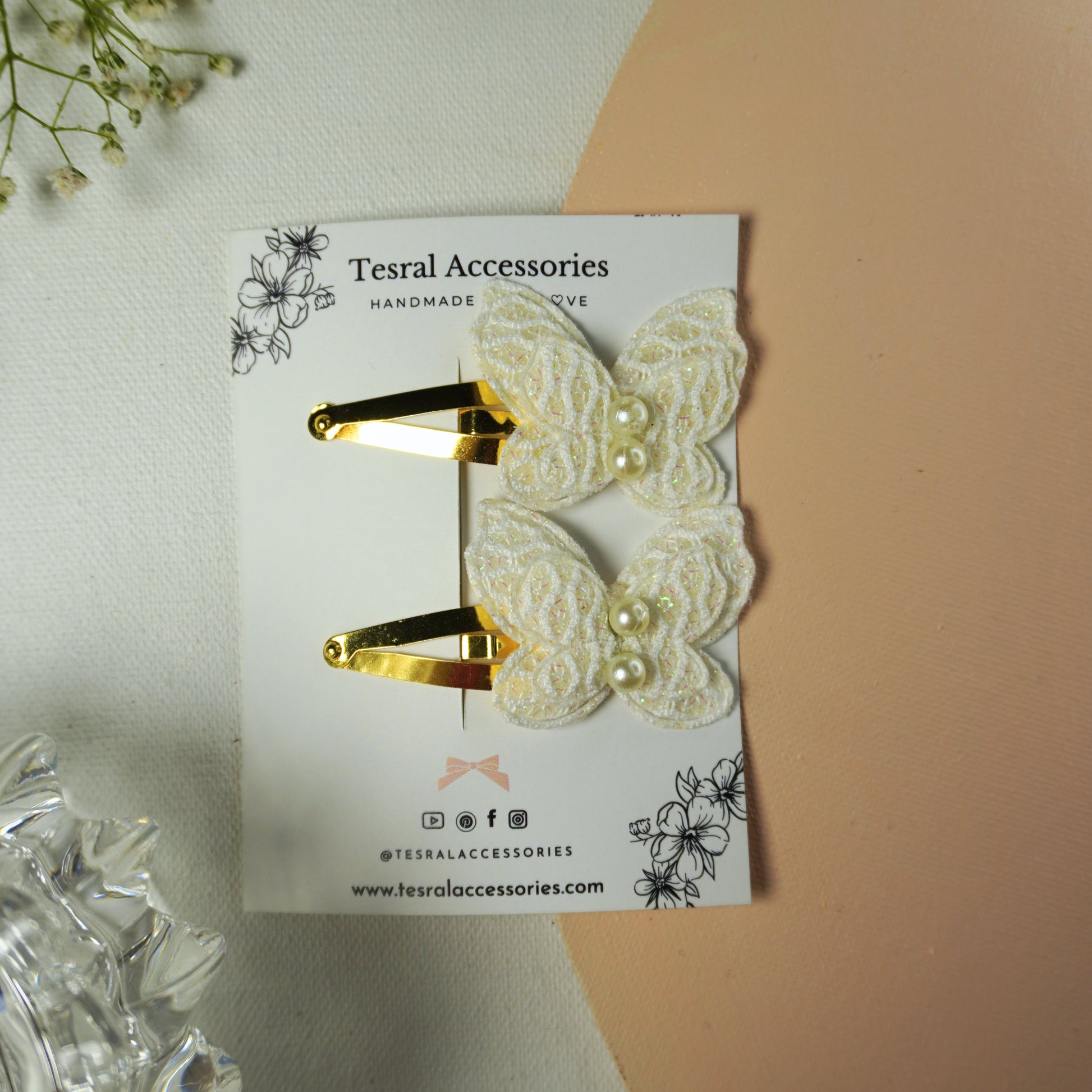 Set of two white lace butterfly hair clips with pearl accents on gold snap clips