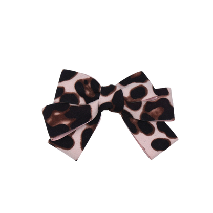 Detailed close-up of Leopard Luxe Hair Bow showcasing plush suede texture and wild leopard pattern.