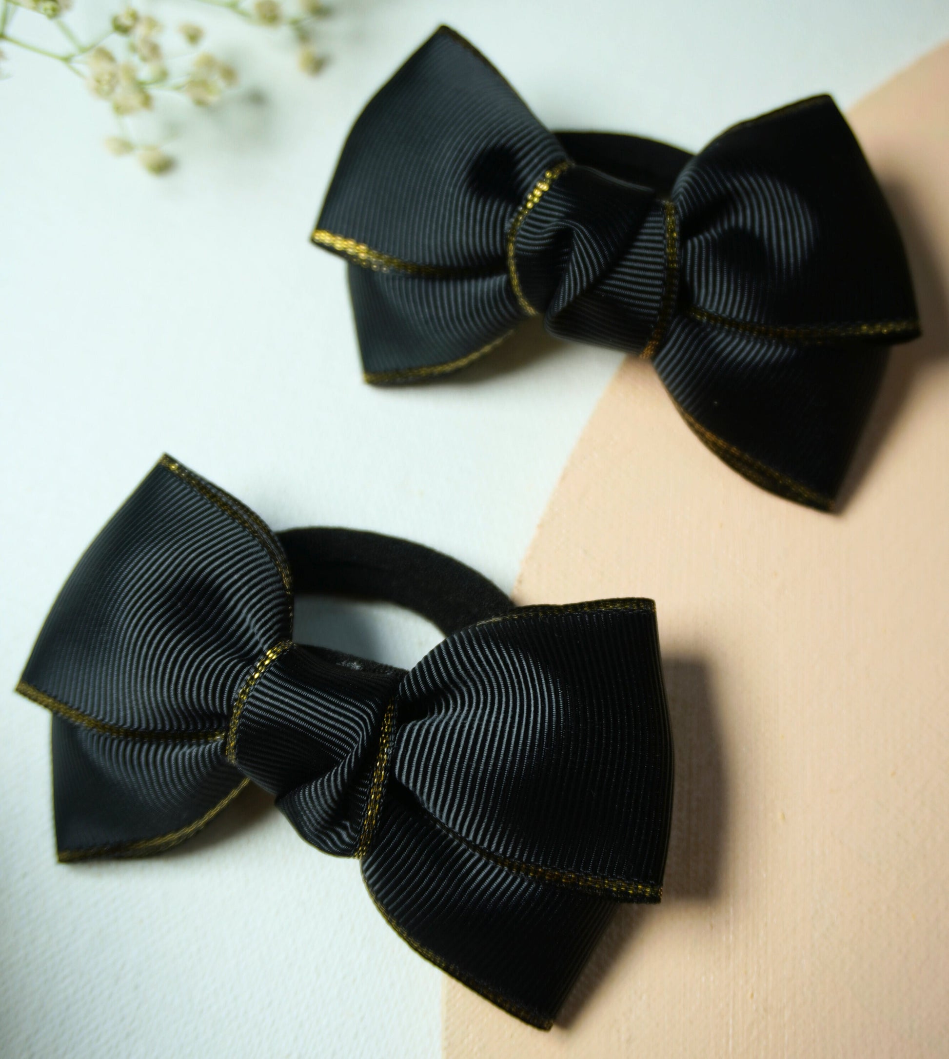 Set of two black grosgrain ribbon bow hair ties with gold metallic edge