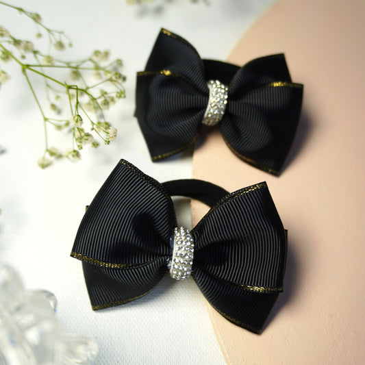 Set of two black grosgrain bow ties with silver edging and rhinestone detail for toddlers