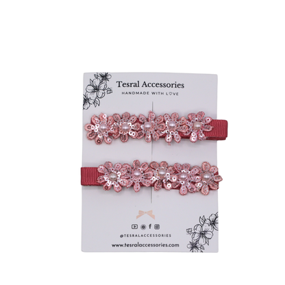 Detailed view of Petal Bloom Clip showing glittering floral embellishment on grosgrain base.