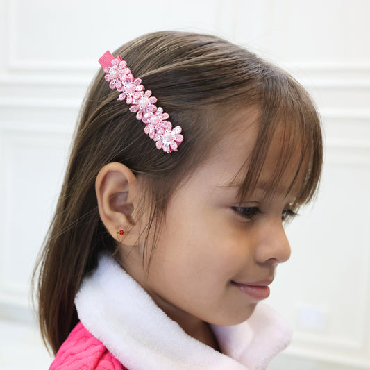 Little girl wearing Tesral Petal Bloom Hair Clip to sweep back thick hair with a touch of sparkle and sequin