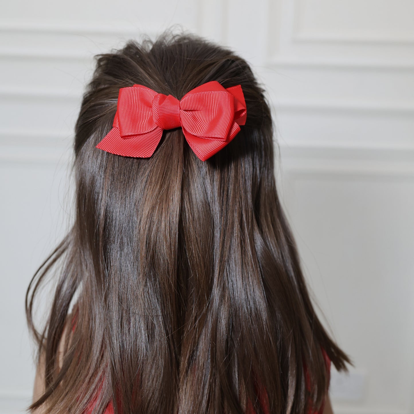 Little girl wearing Tesral Red Spin Hair Bow in festive hairstyle, perfect for party or winter outings.