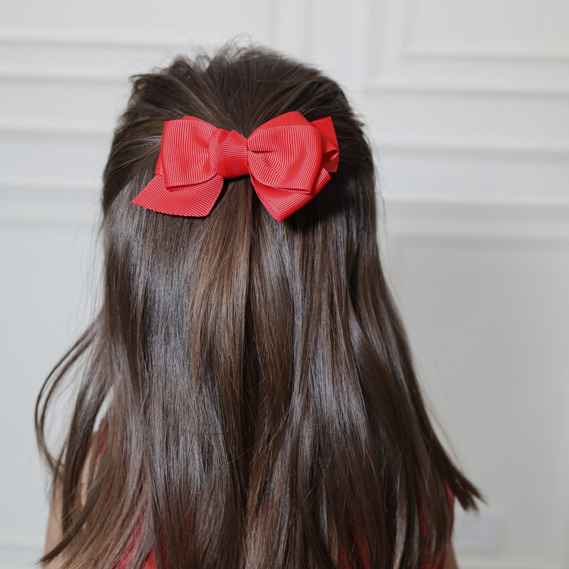 Little girl wearing Tesral Red Spin Hair Bow in festive hairstyle, perfect for party or winter outings.