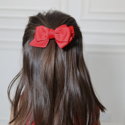 Little girl wearing Tesral Red Spin Hair Bow in festive hairstyle, perfect for party or winter outings.