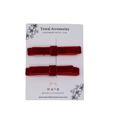 Close-up of Tesral Accessories Red Velvet Twin Bow hair clips, showcasing rich red velvet texture and structured twin bow design with alligator clip backing.