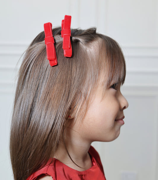 Baby girl wearing Tesral Accessories Red Velvet Twin Bow hair clips, soft velvet bows on 4.5 cm alligator clips, perfect for winter outfits and holiday looks.