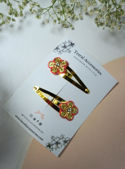 Red and gold Gotta Patti floral hair clips for girls set on golden snap clips
