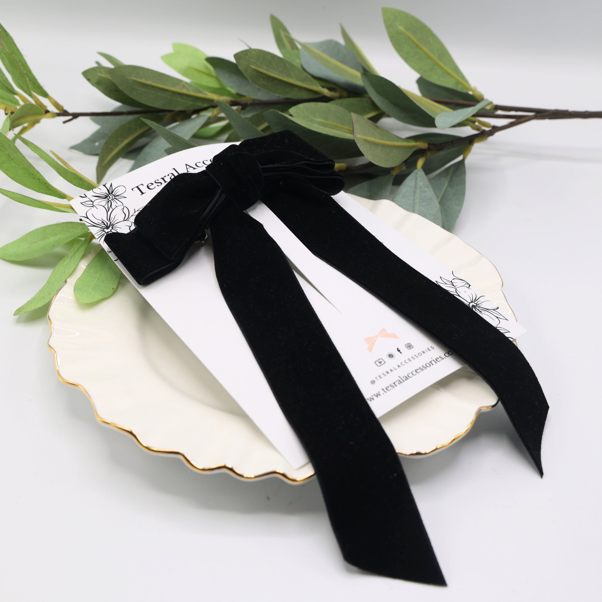 Black velvet Serenity hair bow with long tails on Tesral Accessories display card – elegant barrette clip