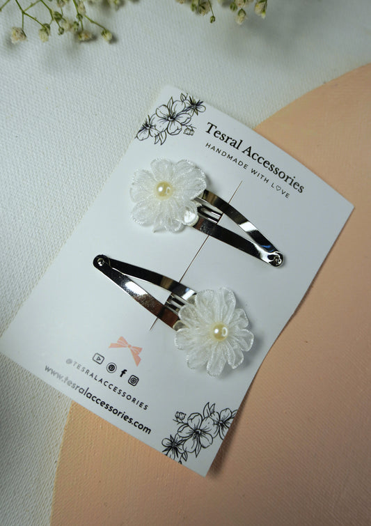 Sheer white organza flower hair clips with pearl centerpiece on silver snap clips