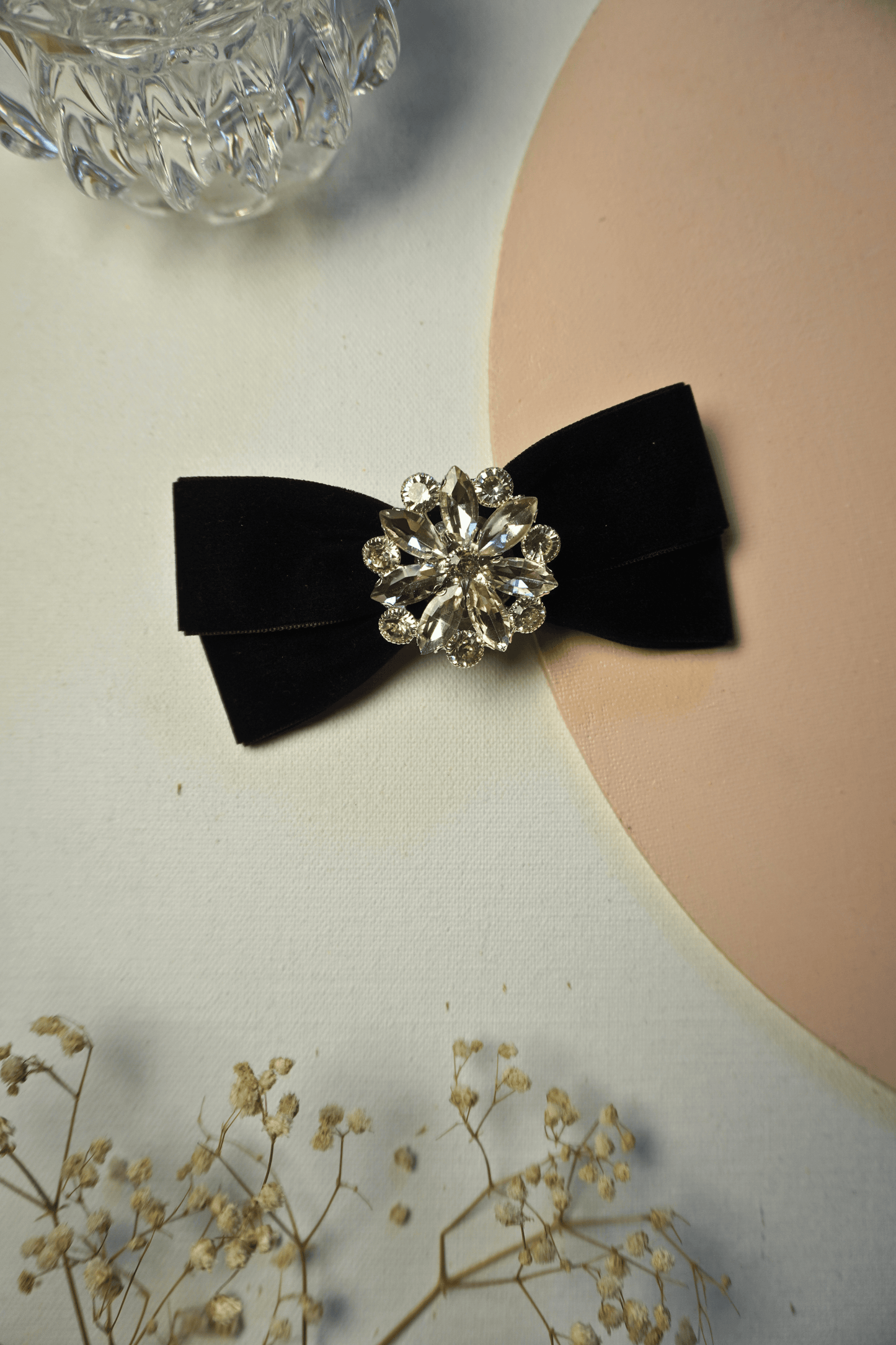 Black velvet luxe hair bow with rhinestone snowflake flower center, festive winter party accessory from Tesral Accessories