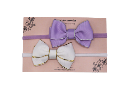 Close-up of lavender and white grosgrain hair bows on soft nylon headbands – handmade baby accessories by Tesral